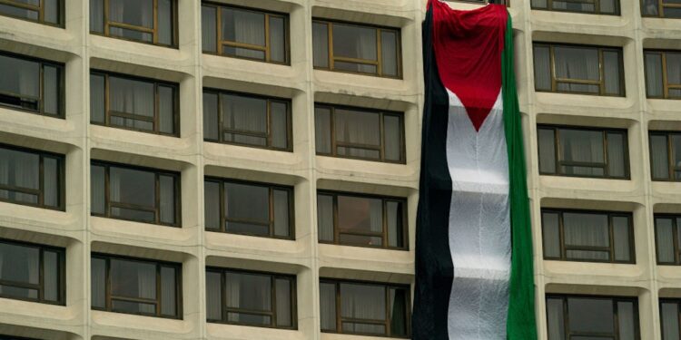 Protesters Swarm White House Correspondents’ Dinner, Drape Massive Palestinian Flag From Hotel Window